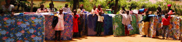 Orphans receiving their new mattresses.